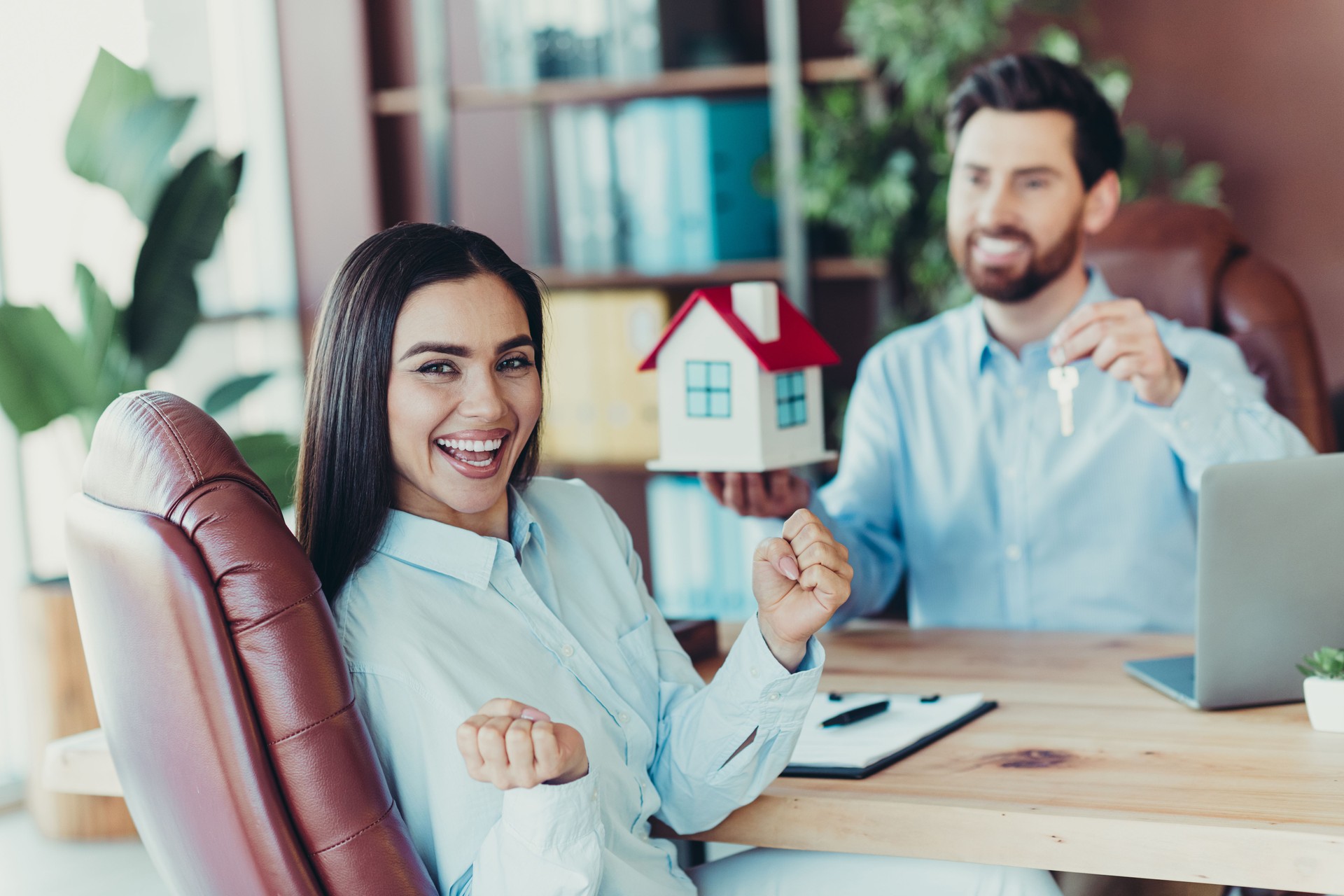 Business professionals celebrating success with teamwork and collaboration in a modern office workspace with vibrancy and positivity.